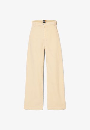 Wide-leg beige corduroy pants with a high waist, front button closure, and a textured fabric. Features classic pockets and subtle stitching.