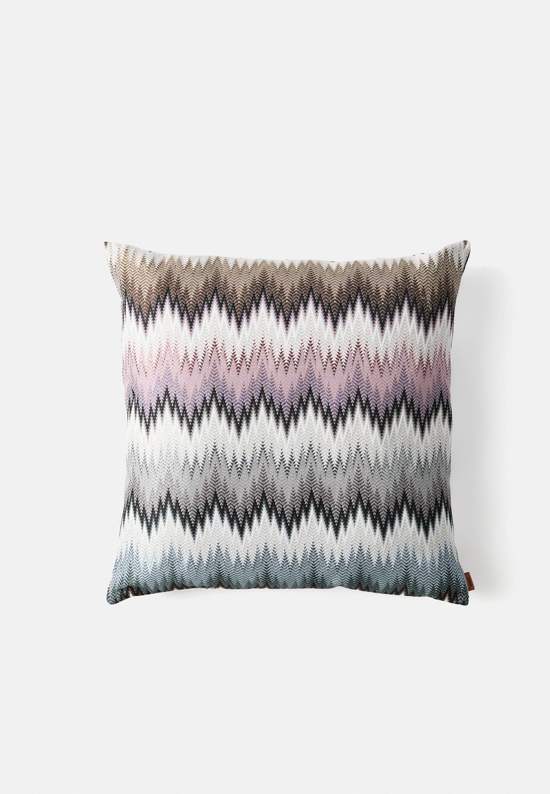 Decorative rectangular pillow with zigzag pattern in shades of brown, pink, white, gray, and blue on a white background.