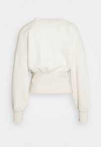 Sweat-shirt à manches longues écru avec une large ceinture élastique, épaules tombantes et poignets ajustés, vu de dos.