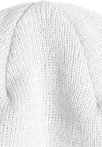 White knitted beanie featuring a textured pattern with a smooth finish, rounded top, and a snug fit, suitable for cold weather wear.