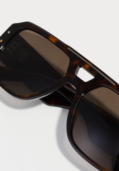 Tortoiseshell sunglasses with dark lenses, featuring a rectangular shape, metal accents, and a cut-out detail in the bridge.