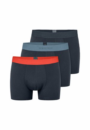 Three pairs of dark navy men's boxer briefs with branded waistbands in red, light blue, and black, arranged in a staggered stack.
