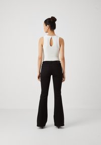 ONLY ONLREESE RETRO - Flared Jeans - washed black