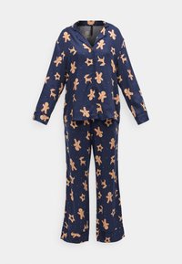 Marineblauw pyjama set met lange mouwen en broekspijpen, versierd met peperkoekmannetjes en sterren in oranje en roomkleur. Gladde stofstructuur.