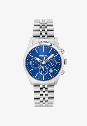 Sølv rustfrit stål kronograf ur med en blå urskive, tre små sub-dials, datovisning og et sammenkoblet metalarmbånd.