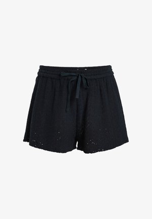 Black cotton shorts with a textured pattern, elastic waistband, and drawstring. Features small cutouts along the hem for added detail.