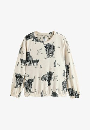 Chemise beige à manches longues ornée d'illustrations noires de vaches des Highlands, petits lapins et fleurs. Tissu doux avec poignets élastiques.