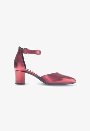 Red metallic high-heeled shoes with a rounded toe, ankle strap, and a block heel. Smooth texture with a reflective finish.