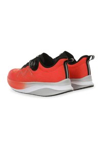 Bright red athletic shoes with a textured fabric upper, a black lacing system, and a flexible white sole featuring a black tread pattern.