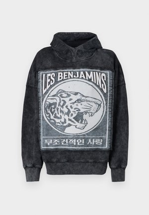 Hoodie en mélange de coton noir avec un grand graphique de tigre et le texte "LES BENJAMINS." Présente un col haut et des accents texturés.