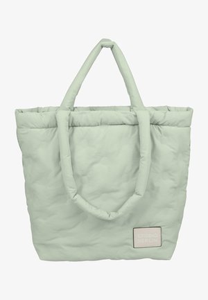 Soe hele roheline pehme kandekott kahe käepidemega, tekstureeritud pind, millel on tõstetud punktid, ja õmmeldud silt, millel on pastellsetes toonides "STUDIO BERLIN".