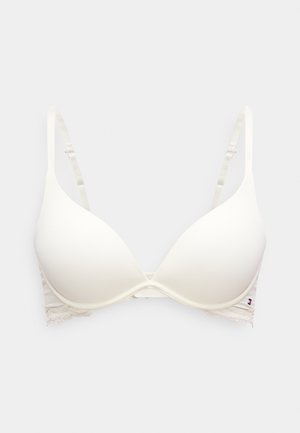 Στρουμπφό μπεζ σουτιέν με μπανέλα, επενδεδυμένο, με ρυθμιζόμενους ιμάντες και δαντέλα κατά μήκος του κάτω άκρου, σε ανοιχτό γκρι φόντο.