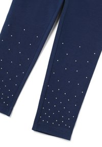 Marine leggings van zachte stof, voorzien van verspreide strass-ornamenten op de onderbenen, wat zorgt voor een tekstuurlijke en decoratieve uitstraling.