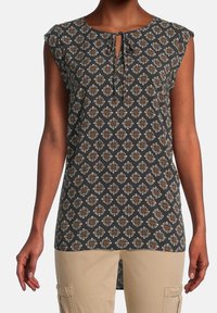 Mouwloze grijze tuniek met een diamantenpatroon in wit en bruin, voorzien van een keyhole-halslijn met een strik. De stof heeft een gladde textuur.