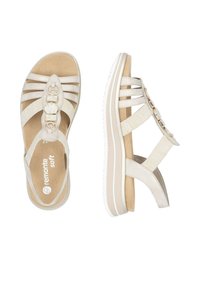 Beige Wedgesandalen mit mehreren Stoffriemen, dekorativen Knöpfen und einer strukturierten Innensohle. Weiche Polsterung und leichte Sohle für Komfort.