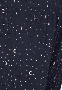 Navy cotton pajama pants with an elastic waistband, featuring a print of white stars and crescent moons across the fabric.