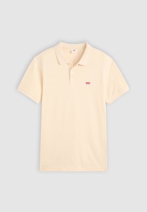 Poloshirt in hellem Creme, aus weichem Baumwollstoff, mit klassischem Kragen, kurzen Ärmeln und einem kleinen roten Levi's-Logo auf der linken Brust.