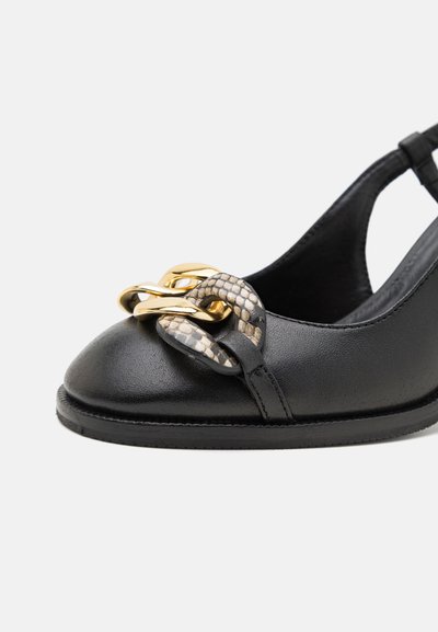Black leather slingback shoe featuring a rounded toe, embellished with a gold and snake-patterned chain accent on the front.