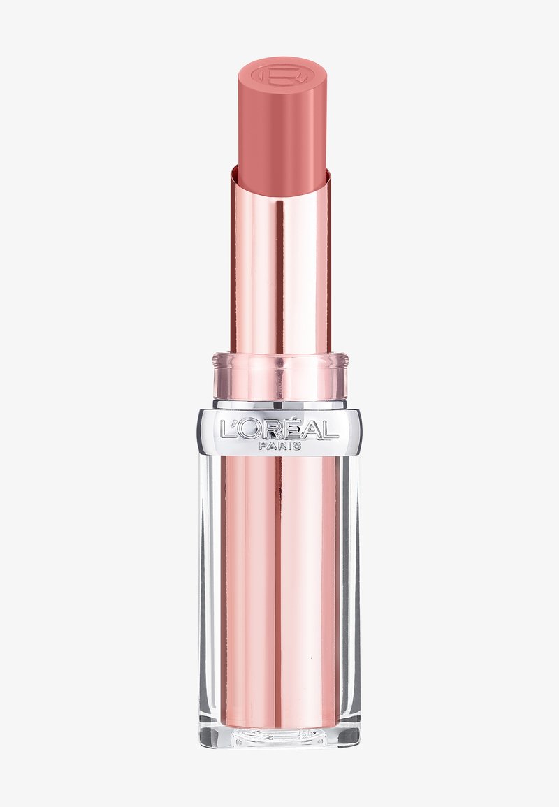 Rossetto in un tubo cilindrico trasparente con un cappuccio metallico color oro rosa. La punta è di una morbida tonalità rosa con una finitura liscia.