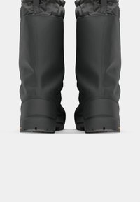 Botas de invierno impermeables negras con un upper texturizado, una sección inferior lisa, suela de goma y punta reforzada; con un puño ajustable mediante cordón.