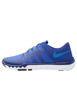 Baskets Nike bleues avec tige en mesh, câbles Flywire et semelle blanche flexible conçue pour la course ou l'entraînement.