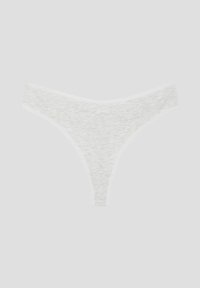 Λευκό γυναικείο στρινγκ εσώρουχο από ριμπ βαμβάκι, απλωμένο επίπεδα σε ανοιχτό φόντο.