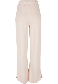 Lys rosa vide bukser med elastisk midje, med sideslisser nederst for ekstra detaljer og en jevn tekstur.