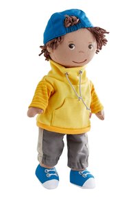 Soft doll with brown yarn hair wearing blue cap backwards, yellow hoodie with striped sleeves, gray pants, and blue sneakers.