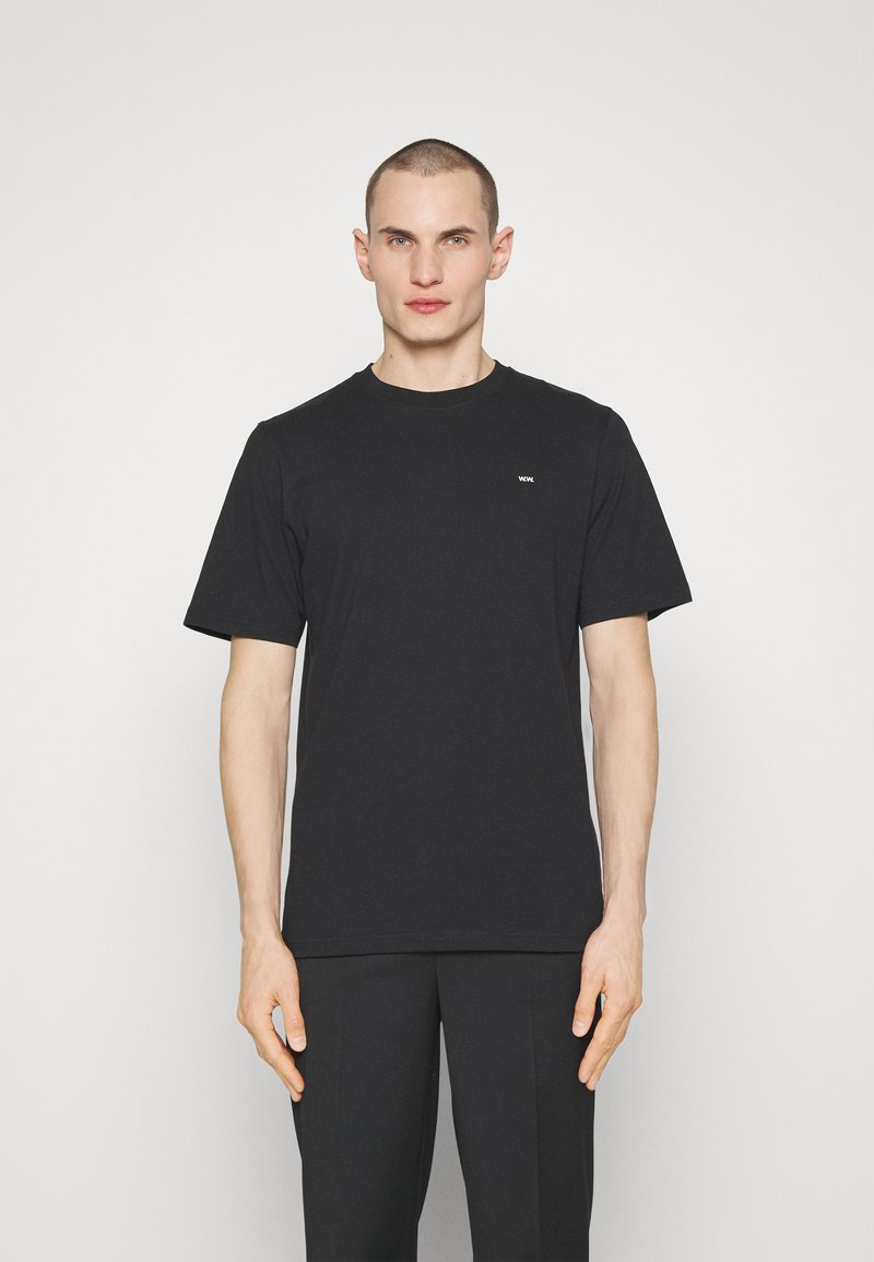 Black short-sleeve t-shirt made of cotton, featuring a crew neck and a small white logo on the left chest. Smooth texture and regular fit.