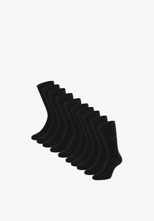 Tien paar effen zwarte sokken tot halverwege de kuit, gerangschikt in een diagonale lijn op een witte achtergrond.