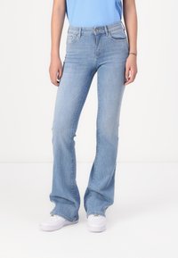 Light blue flared jeans made of denim, featuring a classic five-pocket design, belt loops, and subtle fading along the legs.