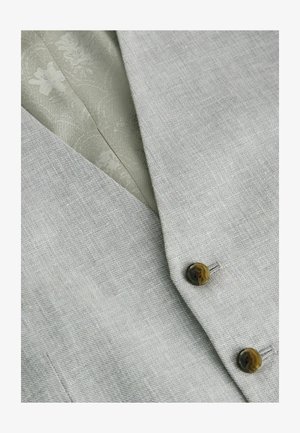 Gilet in lino grigio con due bottoni scuri. Interno foderato con tessuto a motivo floreale leggero di colore verde chiaro.