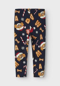 Leggings s uzorkom na tamnoplavoj podlozi s ilustrcijama pasa, slatkiša od mente i kolačića od medenjaka u živopisnim bojama.