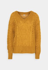 Mosterdgele gebreide trui met V-hals, voorzien van textuurpatronen in kabel en gaatjes, en geribde manchetten en zoom.