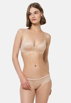 Nude seamless bra with thin adjustable straps and a V-neck design, paired with matching hipster brief. Soft, smooth texture, minimalistic style.