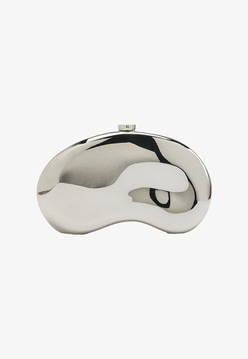Metaliczna srebrna kopertówka o ergonomicznym, abstrakcyjnym kształcie i gładkiej powierzchni. Charakteryzuje się zaokrągloną górą i małym zapięciem na klips.