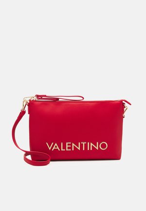 Red leather wristlet clutch with gold-tone zipper and detachable strap, featuring bold gold VALENTINO logo on front.