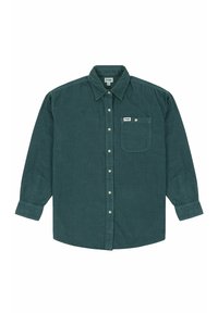 Camicia a maniche lunghe in velluto a coste verde con colletto abbottonato, tasca frontale e dettagli in bianco sui bottoni. Etichetta posizionata sopra la tasca.