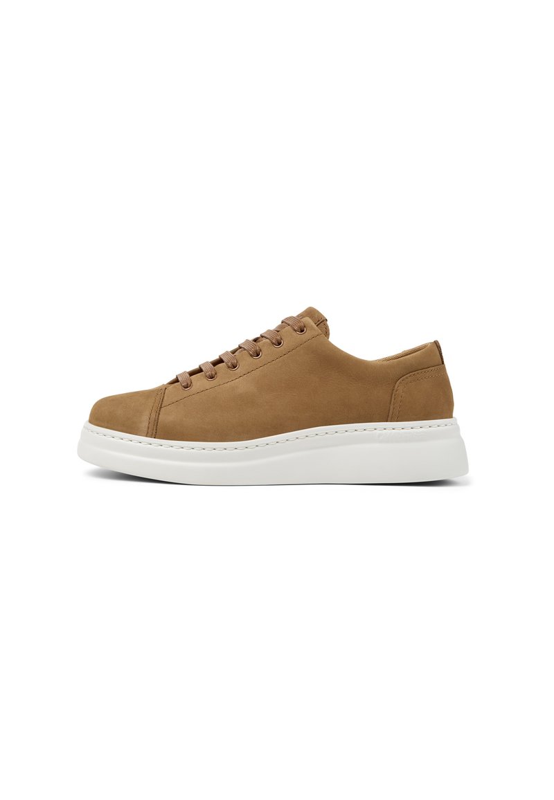 Tan suede sneaker with a white rubber sole, featuring six matching eyelets for laces and a rounded toe design.