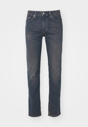 Dark blue denim jeans with a straight leg design, featuring belt loops, a single button closure, and subtle fading texture.