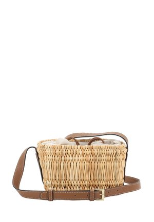 Woven straw crossbody bag with brown adjustable leather strap and a fabric drawstring lining inside.