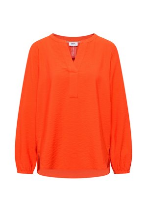 Blusa de manga larga de color naranja brillante con cuello redondo y una abertura corta en la parte delantera, con puños elásticos y un dobladillo ligeramente curvado.