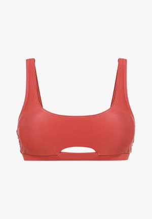 Koralen športni nedrček z širokimi naramnicami, gladko teksturo in središčno obliko s ključavnico. Ima ravne šive in prilegajoč dizajn.