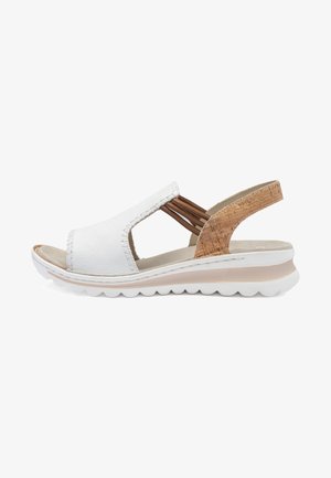 White open-toe sandal with brown elastic side straps, cork-textured heel strap, cushioned sole, and white waffle-patterned outsole.