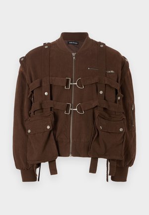 Brown bomber jacket made of fabric, featuring zip closure, multiple straps, and pockets with snap buttons. Ribbed cuffs and hem.