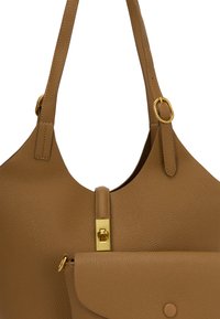 Tan leather tote bag with textured surface, gold-tone hardware, single strap and front flap pocket. Sleek and functional design.