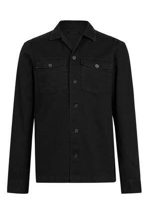 Black button-up shirt in a smooth, matte finish. Features two front pockets, pointed collar, long sleeves, and contrasting stitching.