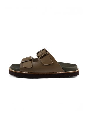 Brown leather slide sandal with two adjustable buckles, cushioned dark insole, and thick textured sole.