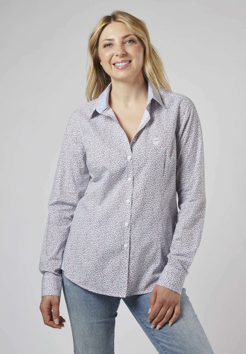 Chemise à manches longues à boutons en tissu léger avec un petit motif floral, des accents de col bleu et une poche poitrine. Coupe normale.
