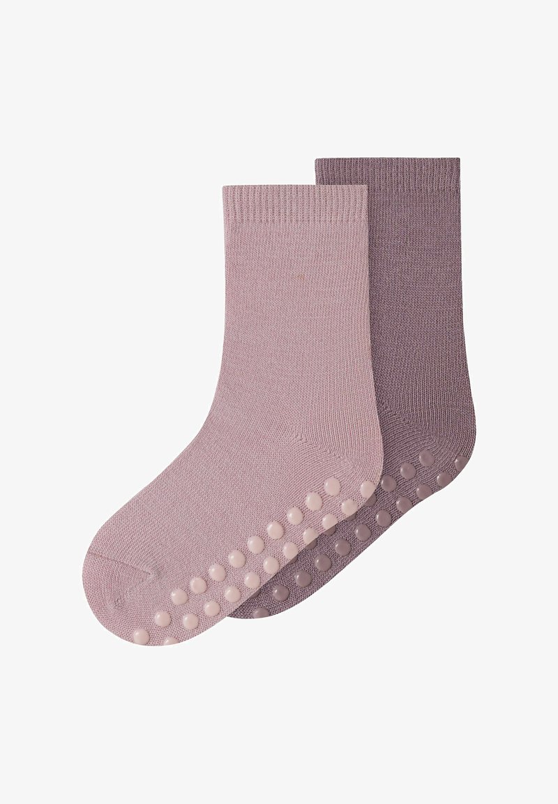Chaussettes en coton de couleur rose clair et violet doux, avec des points d'adhérence texturés sur les semelles et des bords-côtes. Matière douce et respirante.